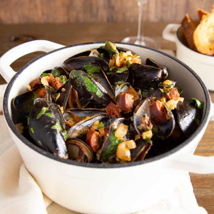 Dutch oven filled with mussels steamed with Spanish chorizo and wine
