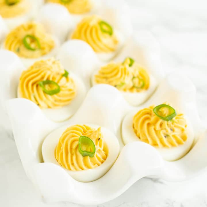 Deviled eggs, the classic party snack, have infinite variations. Here's a simple recipe with many options for garnishes and add-ins to make them your own. #deviledeggs