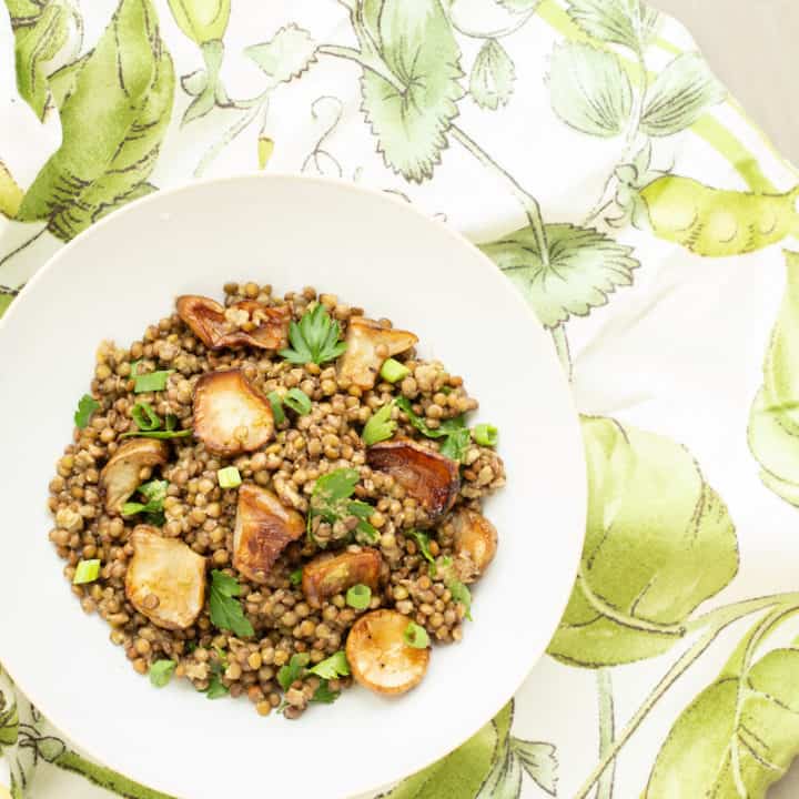 A warm lentil salad mixes French lentils with roasted Jerusalem artichokes, or sunchokes, in a cozy and comforting vegetarian winter dish.