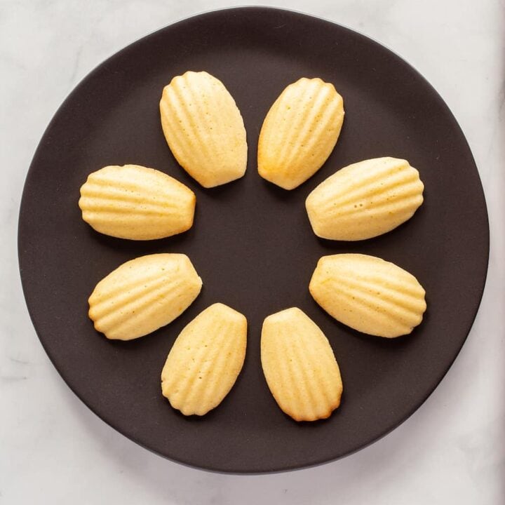 plate of lemon brown butter madeleines arranged in a circle