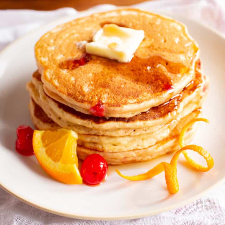 old fashioned pancakes with orange and maraschino cherries