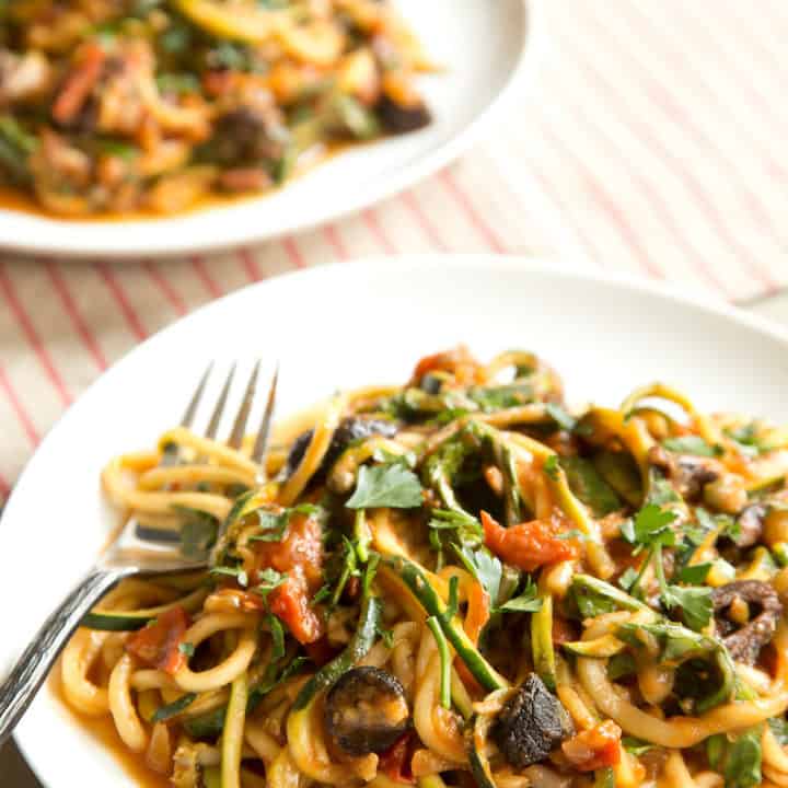 Vegan zucchini puttanesca made with spiralized zucchini noodles is a boldy flavored, surprisingly filling dish that won't weigh you down. #zoodles #zucchininoodles #vegan