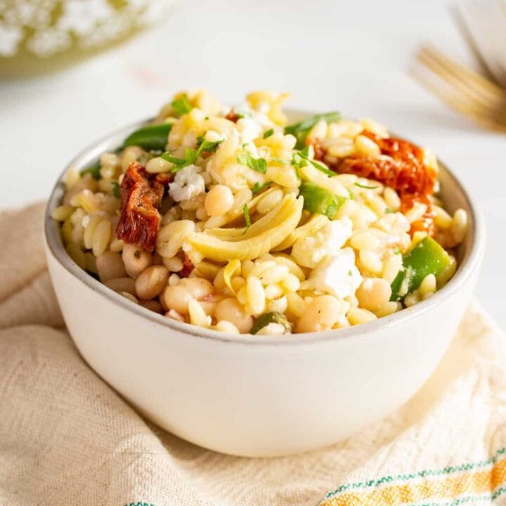 bowls of mediterranean orzo salad with green beans and sun-dried tomatoes