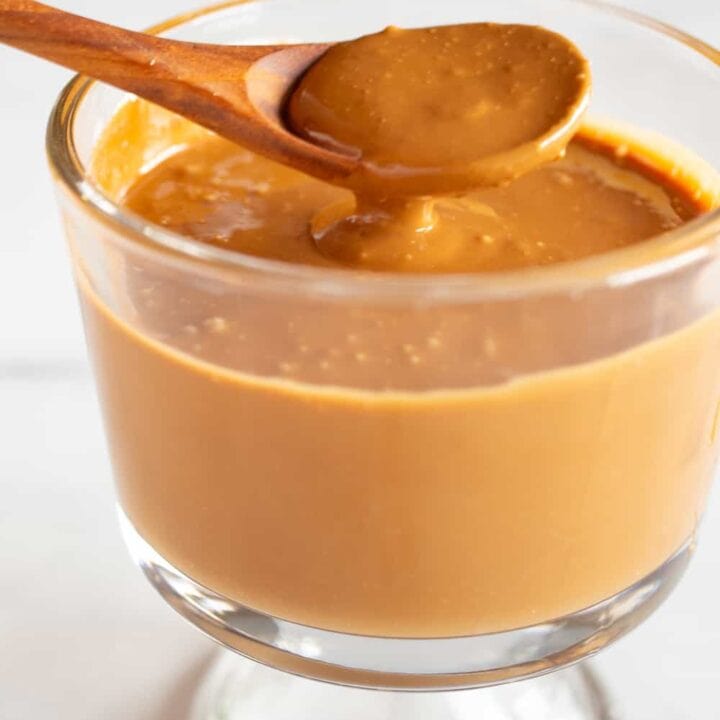 spooning caramelized white chocolate out of a cup