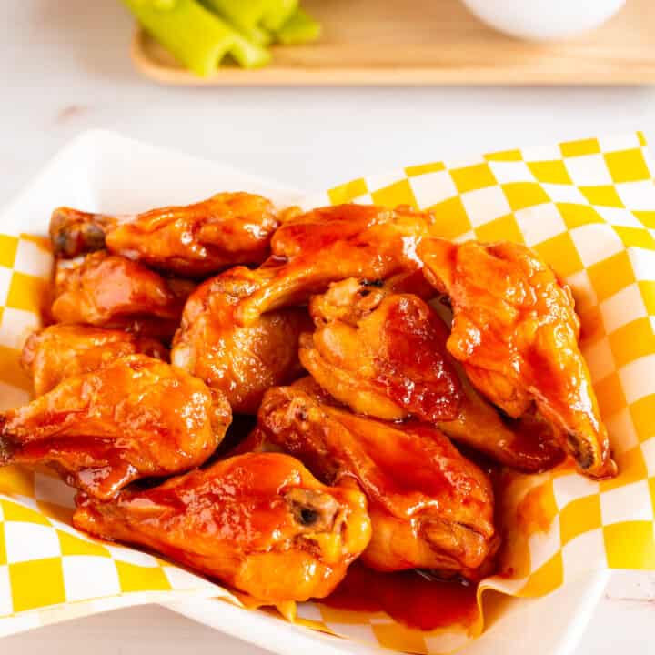 basket of fried chicken wings in brown sugar buffalo wing sauce