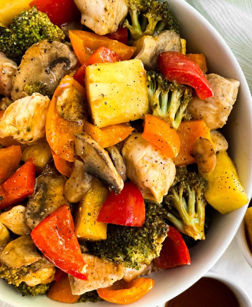close up of hawaiian chicken and veggies in a white bowl