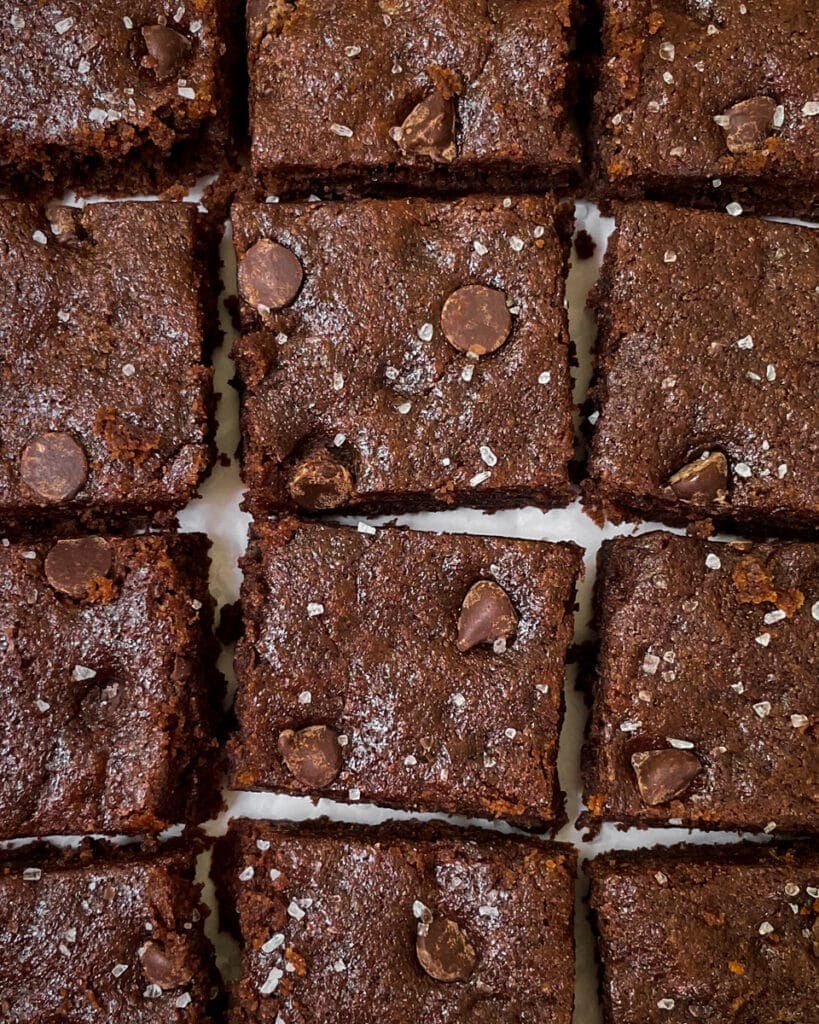 Overhead view close-up of tahini brownie grid with salt sprinkled atop.
