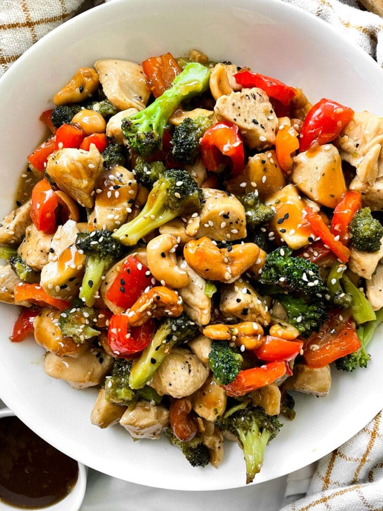 top view of thai chicken with cashews and broccoli in a white bowl