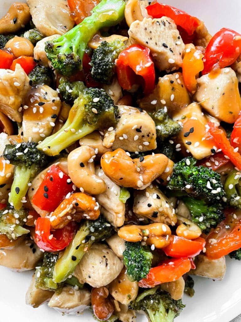 close up of thai cashew chicken after cooking with seeds for garnish