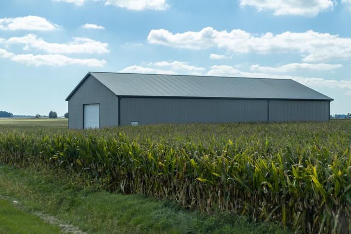 Steel machinery storage building beside a farm field