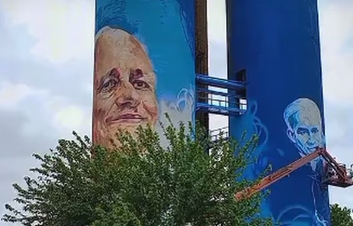 En este momento estás viendo Don Orione: pintan un mural gigante en los tanques para homenajear a tres figuras religiosas