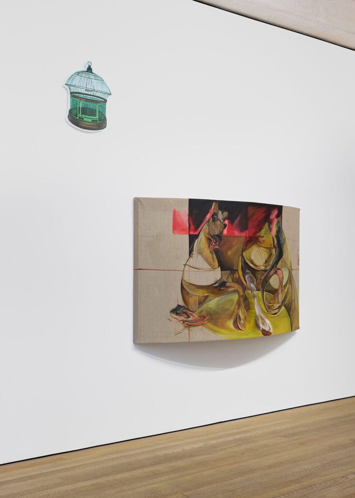 A modern art gallery wall displays a green birdcage sculpture above an abstract painting, part of Crude Hints Towards curated by Charlotte Edey at Ginny on Frederick for Frieze 2025, with distorted figures and bold red, yellow, and brown tones.