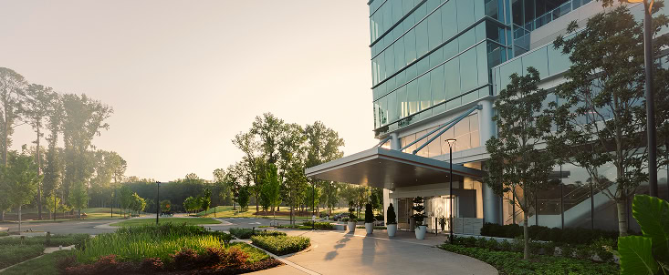 An exterior view of the lush landscaping surrounding 1000 Social, a luxury office space in Raleigh