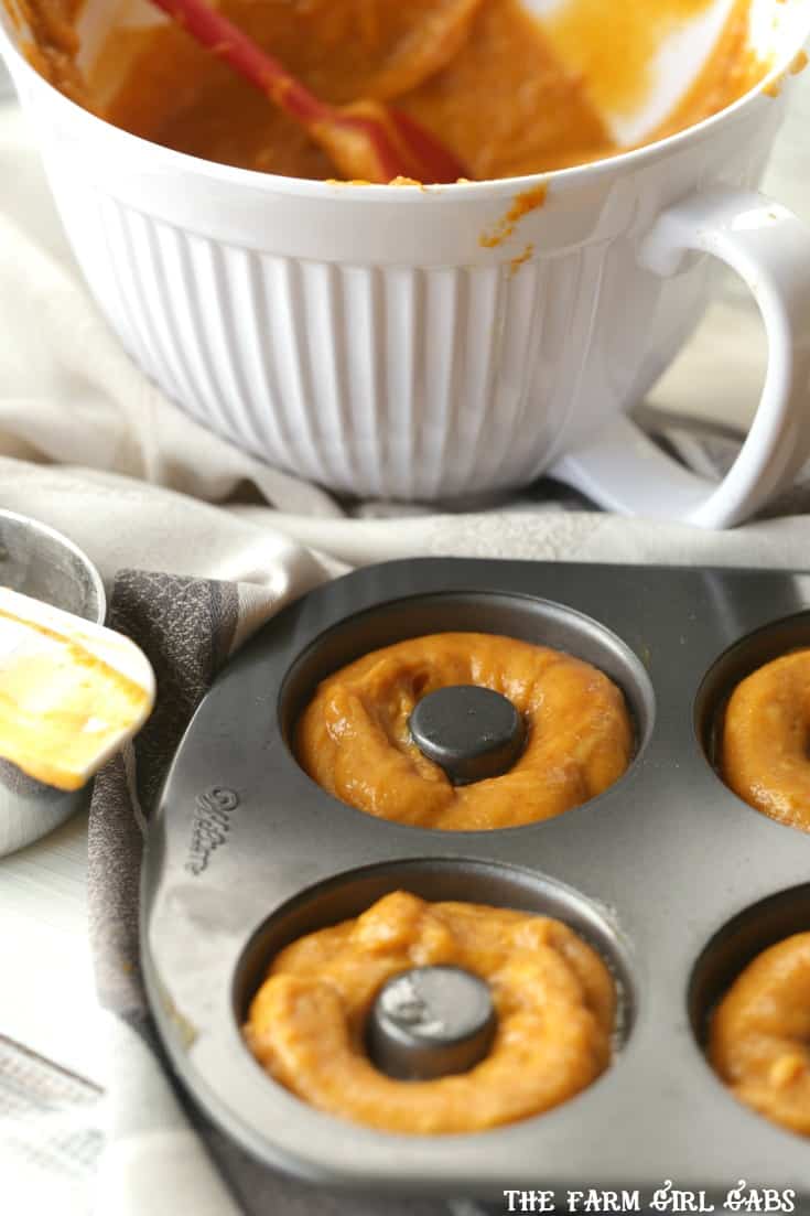 These moist and fluffy Maple Glazed Pumpkin Doughnuts are baked, not fried and are really easy to make. #doughnuts #pumpkin #fallrecipe #dessert