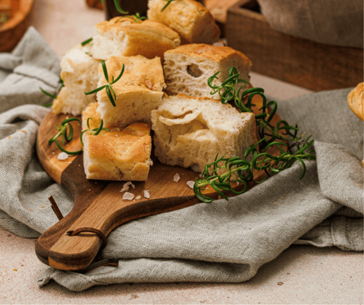 Close-up of stacked homemade focaccia bread showing the soft, airy interior and golden crust.