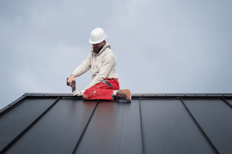 An expert roofer working on the installation of a roof. Get your free estimate today.
