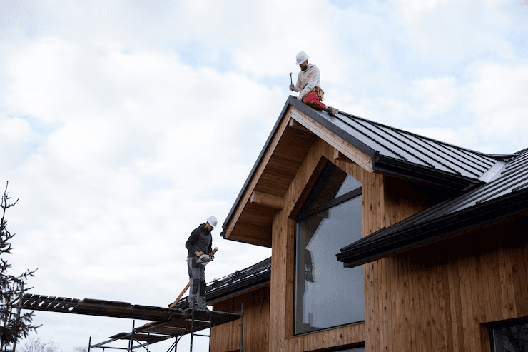 Licensed roofing contractors working on the installation of a residential rooftop. To get an estimate, get in touch with us today.
