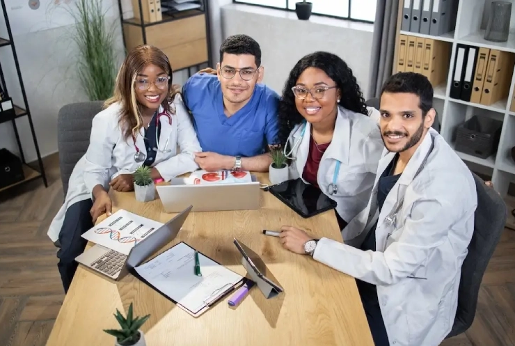 Multiracial team of doctors collaborating at a table, symbolizing professional healthcare services in Qatar