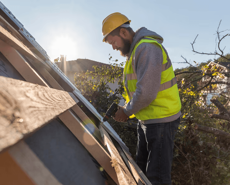 A professional roofer working on the installation of a rooftop. Contact us to get a free estimate.
