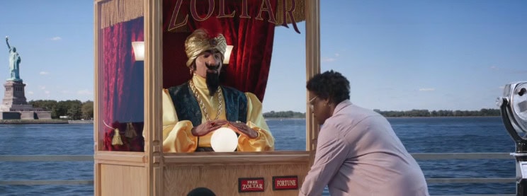 Puppet performer in costume on a boat during a waterfront event.