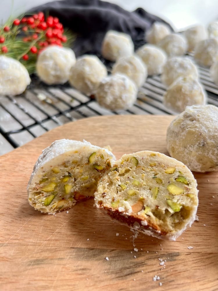 Pistachio Snowball Cookies 1 Pistachio Snowball Cookies with one cookie cut in half to see the inside