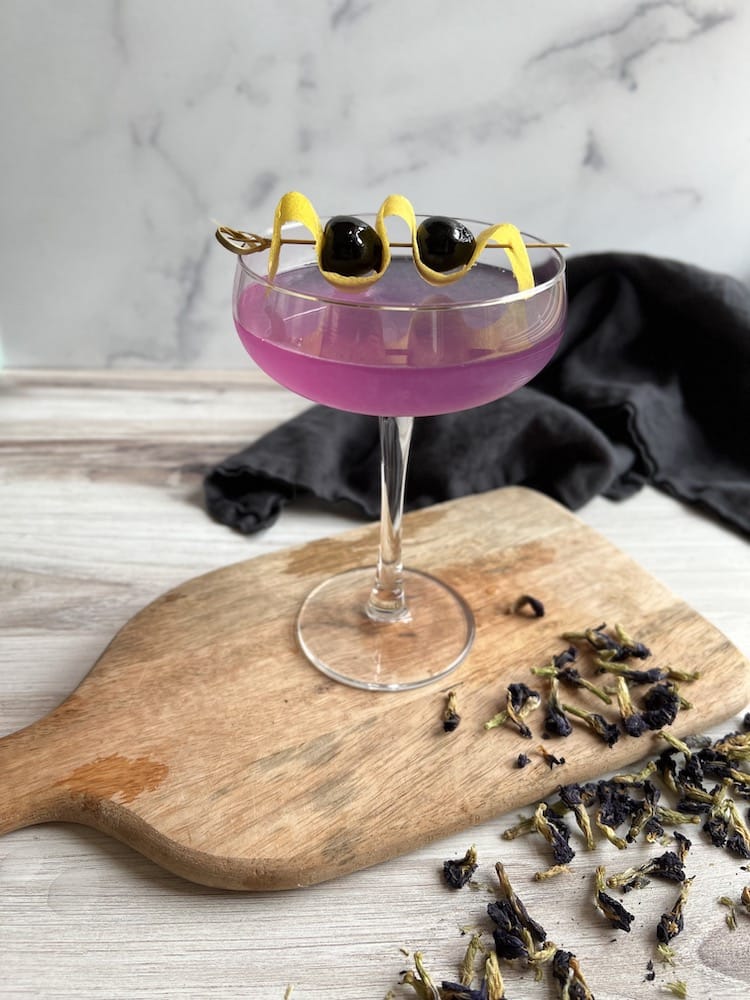 Aviation Mocktail 1 Aviation Mocktail in a coupe glass on a cutting board