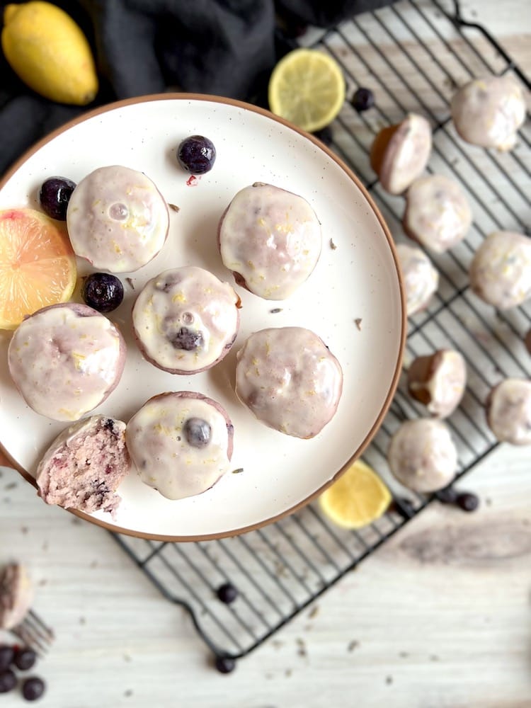 Blueberry Lavender Mini Muffins 1 Blueberry Lavender Mini Muffins on a plate with one cut in half.