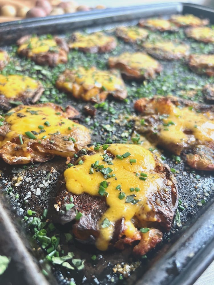 Cheesy Smashed Potatoes 1 Cheesy Smashed Potatoes on a baking tray