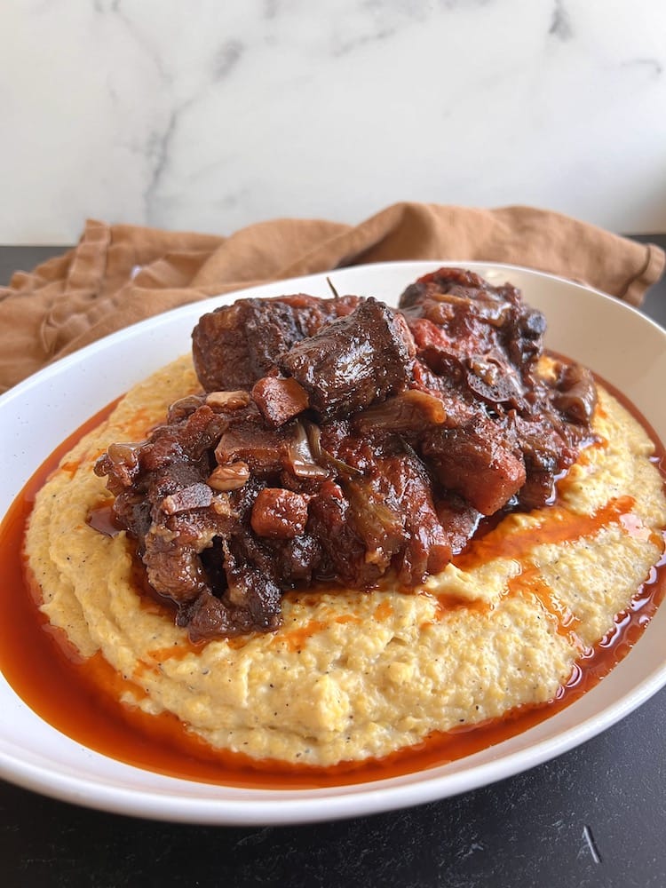 Italian Braised Oxtail 1 Italian Braised Oxtail served over Creamy Polenta in a large serving dish