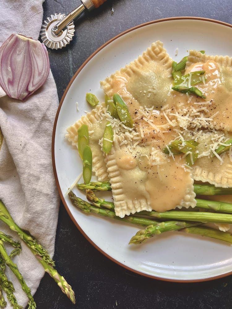 Asparagus Ravioli with Lemon Beurre Blanc 1 Asparagus Ravioli with Lemon Beurre Blanc on a plate with blanched asparagus