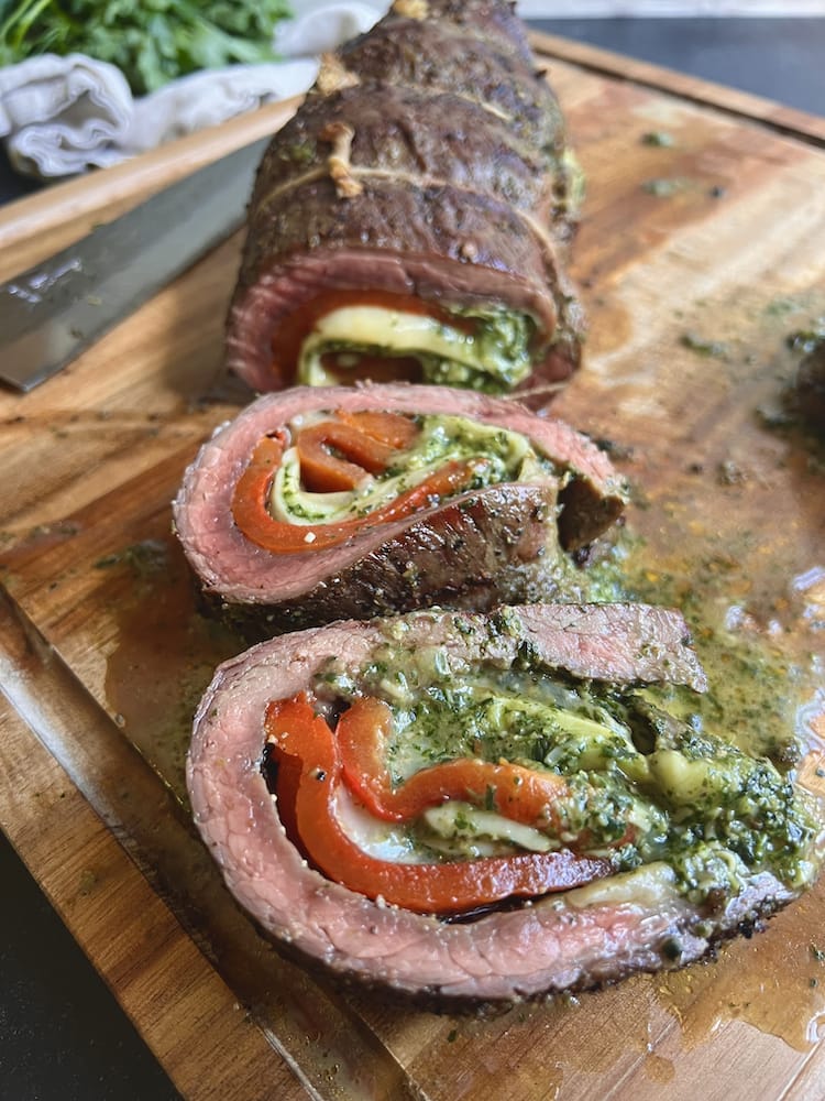Grilled Italian Beef Roulade 2 COPY Grilled Italian Beef Roulade sliced and laying on wooden cutting board