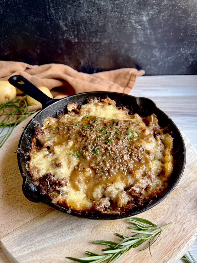 Beef and Potato Skillet Pie 3 WEB Beef and Potato Skillet Pie in a cast iron pan on a wooden cutting board