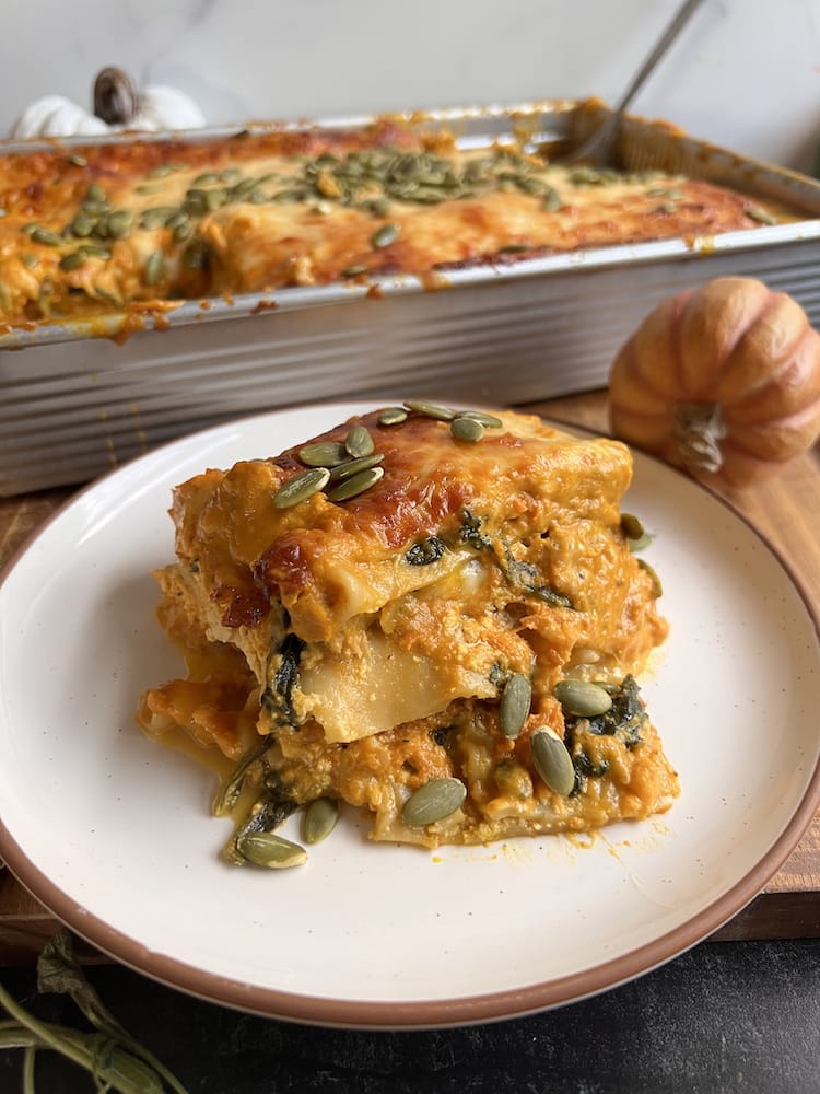 Pumpkin Lasagna 2 WEB A serving of Pumpkin Lasagna on a white plate with the remaining pan of lasagna behind it