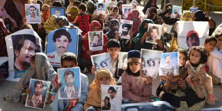 Relatives of missing Pakistanis hold pictures of their loved ones in a demonstration during Human Rights Day in Quetta, the capital of Balochistan province, on December 10, 2018