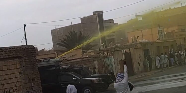 An image provided by an eyewitness on Friday 20 October 2023 shows a water cannon spraying yellow liquid to disperse protests and facilitate subsequent arrest of marked protesters.