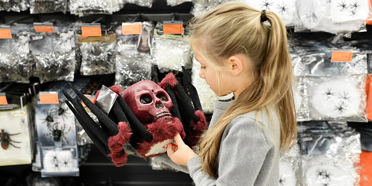 Halloween costume skull mask with red fur, girl shopping for spooky accessories at a store, Halloween decorations and masks, horror-themed costume ideas, festive costume shopping for Halloween.
