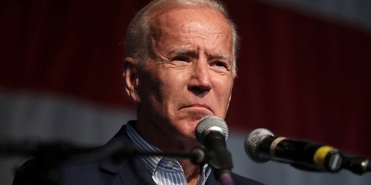 Distressed man speaking into microphones, emotional expression at political event or press conference.