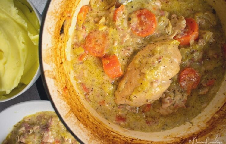 Close up of chicken and cider casserole in cooking pan, mash and served portion to side, leaving shot