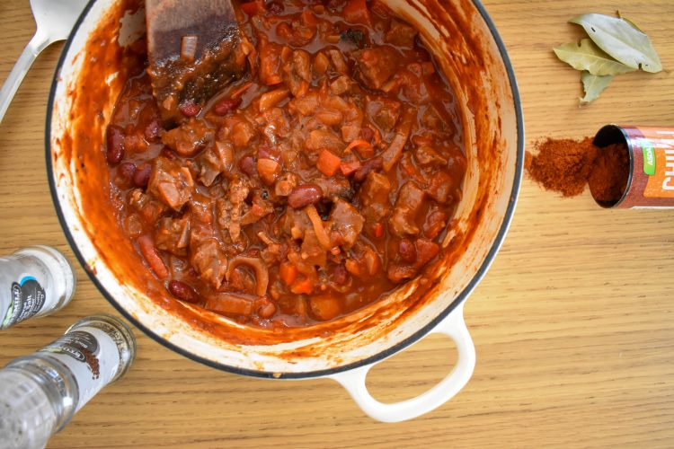 Closer shot of chilli in ovenproof dish.