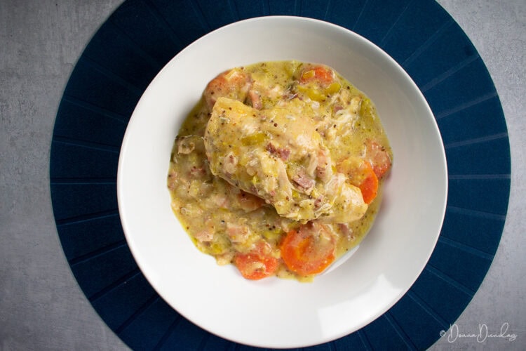 close up, top view of served chicken breast and carrots in cider and mustard sauce