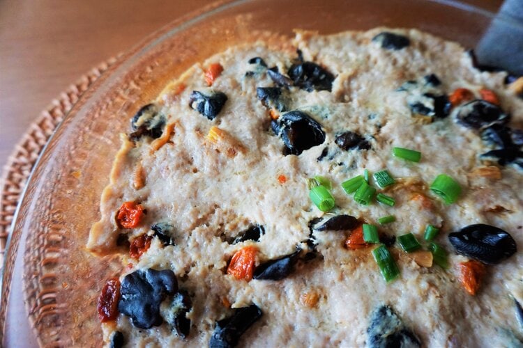 Meat patty with black fungus close up in a glass dish