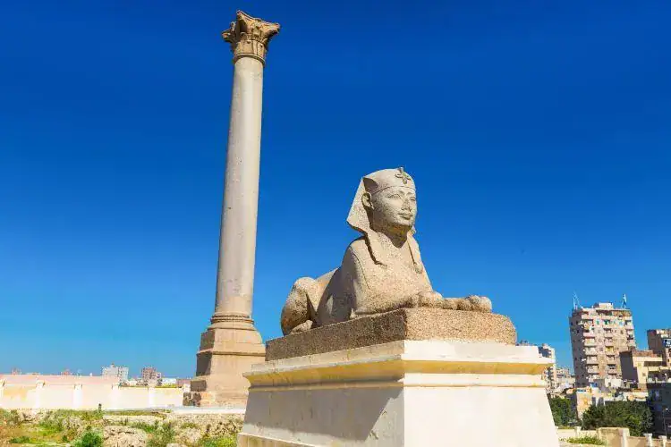 Pompey’s Pillar Alexandria beside an ancient granite sphinx