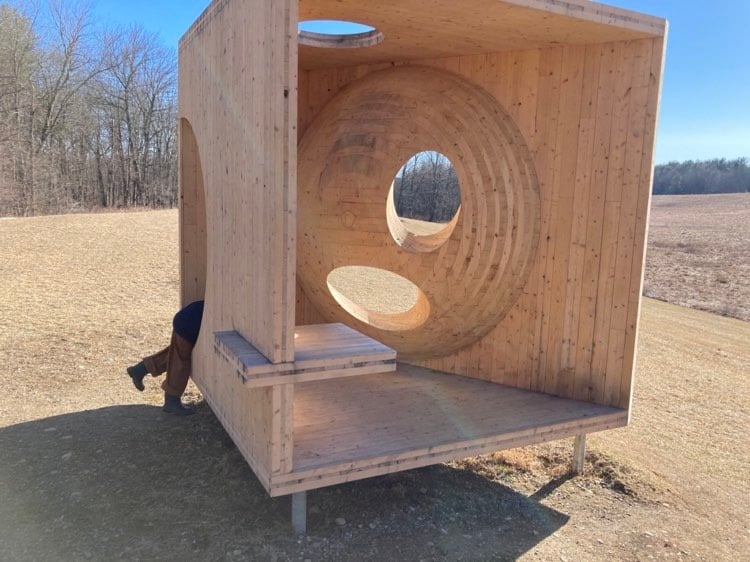 Little boy climbing on art structure in the Omi Art Center