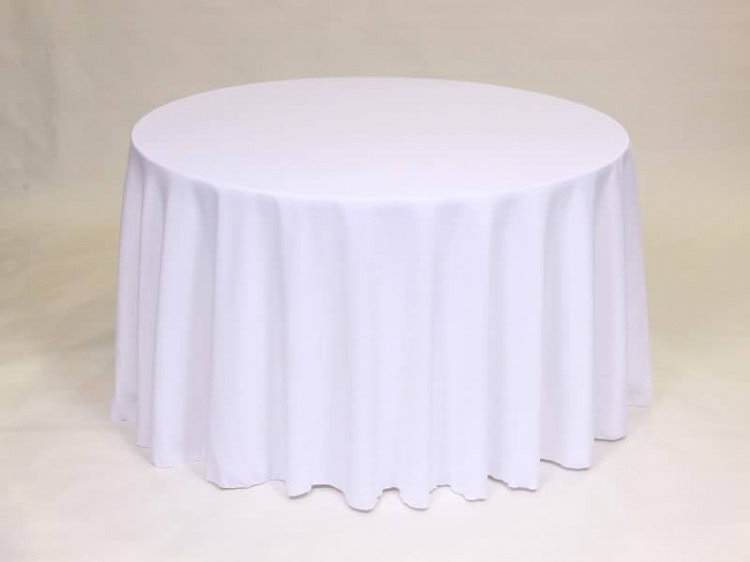 White 120 inch round polyester tablecloth on a round table