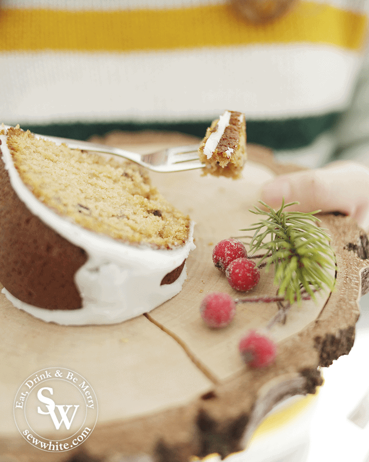 a gorgeous slice of Mince Pie Christmas Bundt Cake on a log slice plate and cake fork