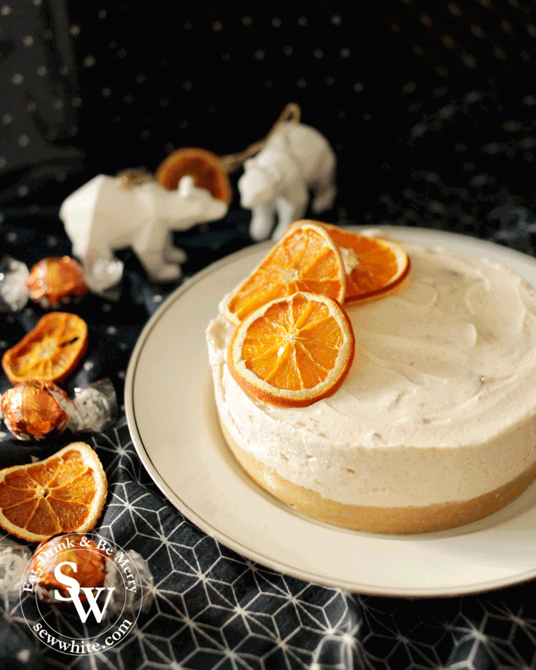 dried orange slices adorns the beautiful orange Christmas cheesecake