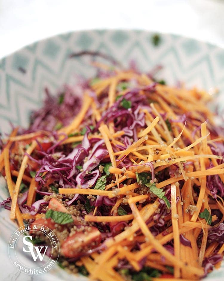 A rich and vibrant easy vegan rainbow salad with red cabbage carrots tomatoes quinoa and mint