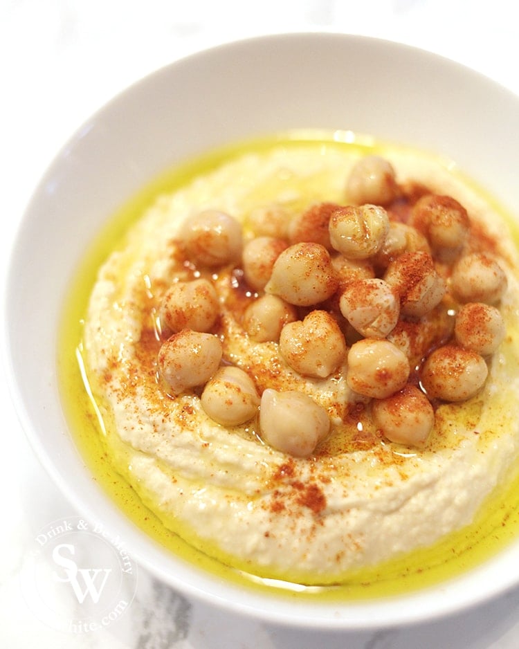 Homemade Vegan Hummus topped with chickpeas olive oil and paprika