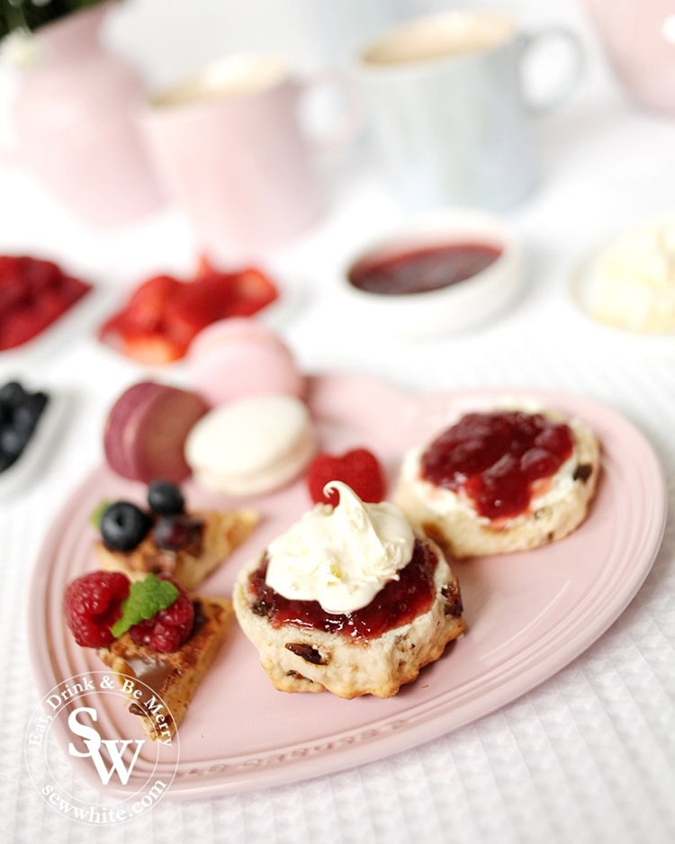 Freshly made scones with clotted cream and jam perfect for mother's day on the heart shaped plate from Le Crueset.