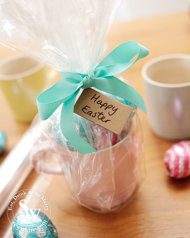 Cellophane wrapped mug with Easter eggs and a brown paper tag. Easter presents.